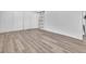 Bedroom showcasing wood-look floors and a sleek closet with a stylish barn door for easy access at 747 Greenbriar Townhouse Way, Las Vegas, NV 89121