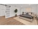 Charming bedroom features a barn door closet, neutral decor, and ample natural light at 747 Greenbriar Townhouse Way, Las Vegas, NV 89121