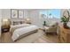 Inviting bedroom with a comfortable bed, stylish furnishings, and an abundance of natural light at 747 Greenbriar Townhouse Way, Las Vegas, NV 89121