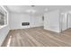 This spacious living room boasts stylish wood-look floors and a modern fireplace feature wall at 747 Greenbriar Townhouse Way, Las Vegas, NV 89121