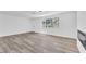 Spacious living room with modern gray plank floors and plenty of natural light at 747 Greenbriar Townhouse Way, Las Vegas, NV 89121