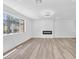 Open-concept living room with modern fireplace, recessed lighting, and gray plank flooring at 747 Greenbriar Townhouse Way, Las Vegas, NV 89121
