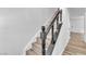 Wooden staircase with a modern, painted black banister leads to the next floor at 747 Greenbriar Townhouse Way, Las Vegas, NV 89121