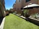 Landscaped backyard featuring artificial turf and beautiful plants at 7537 Brisa Del Mar Ave, Las Vegas, NV 89179