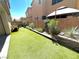 Manicured backyard featuring artifical grass, a stylish gazebo, and beautiful landscape design at 7537 Brisa Del Mar Ave, Las Vegas, NV 89179