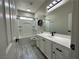 Well-lit bathroom features a shower-over-tub and modern white vanity at 7537 Brisa Del Mar Ave, Las Vegas, NV 89179