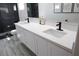 Bathroom vanity featuring dual sinks, modern black fixtures, and plenty of counter space at 7537 Brisa Del Mar Ave, Las Vegas, NV 89179