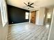Bright bedroom with gray wood floors, a black accent wall and unique sliding barn doors at 7537 Brisa Del Mar Ave, Las Vegas, NV 89179