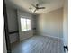 Sunny bedroom with two built in shelves and light gray plank flooring at 7537 Brisa Del Mar Ave, Las Vegas, NV 89179