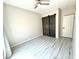 Bedroom with wood grain floors, neutral paint, ceiling fan, and a barn door to the walk-in closet at 7537 Brisa Del Mar Ave, Las Vegas, NV 89179