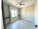 Cozy bedroom featuring neutral walls, wood grain floors, ample natural light, and a ceiling fan at 7537 Brisa Del Mar Ave, Las Vegas, NV 89179
