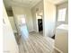 Bright hallway leading to a bedroom with a laundry area featuring a washing machine and plenty of natural light at 7537 Brisa Del Mar Ave, Las Vegas, NV 89179
