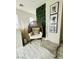 Cozy hallway nook with accent chair, leaf wall art, and modern decor at 7537 Brisa Del Mar Ave, Las Vegas, NV 89179