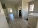 Hallway and Laundry Room featuring gray plank flooring at 7537 Brisa Del Mar Ave, Las Vegas, NV 89179
