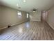 Spacious living room with gray tone plank flooring and modern ceiling fan at 7537 Brisa Del Mar Ave, Las Vegas, NV 89179