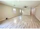 Spacious living room boasting wood grain floors, neutral walls, and large windows, perfect for comfortable living at 7537 Brisa Del Mar Ave, Las Vegas, NV 89179
