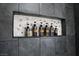 Stylish shower niche with decorative tile and neatly arranged bath and body products at 7537 Brisa Del Mar Ave, Las Vegas, NV 89179