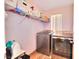 Functional laundry room equipped with modern washer and dryer units and shelving at 759 Sunrise Crossing St, Henderson, NV 89014