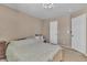 Neutral bedroom with a large bed and two closets at 7720 Leavorite Dr, Las Vegas, NV 89128