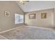 Bright bedroom featuring neutral walls and flooring, large windows, modern ceiling fan and a patterned area rug at 7720 Leavorite Dr, Las Vegas, NV 89128