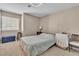 Neutral bedroom with a large window and comfortable furnishings at 7720 Leavorite Dr, Las Vegas, NV 89128