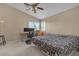 Cozy bedroom featuring carpet, ceiling fan and vaulted ceiling at 7720 Leavorite Dr, Las Vegas, NV 89128
