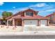Charming two-story home with a three car garage and a low maintenance front yard with desert landscaping at 7720 Leavorite Dr, Las Vegas, NV 89128