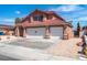 Charming two-story home with a red tile roof and three-car garage at 7720 Leavorite Dr, Las Vegas, NV 89128