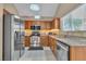 Updated kitchen featuring stainless steel appliances, granite countertops, wood cabinets, and modern fixtures at 7720 Leavorite Dr, Las Vegas, NV 89128
