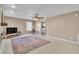 Spacious living room featuring neutral walls, ceiling fan and a large patterned rug at 7720 Leavorite Dr, Las Vegas, NV 89128