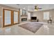 Cozy living room with fireplace, ceiling fan and tile floors at 7720 Leavorite Dr, Las Vegas, NV 89128