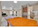 Open-concept living space with stairway and built-in desk; wood-look floors at 7720 Leavorite Dr, Las Vegas, NV 89128