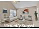 Bright living room featuring neutral walls, vaulted ceilings, and large windows allowing natural light at 7720 Leavorite Dr, Las Vegas, NV 89128