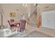 Spacious living room featuring stairs to the second floor, neutral walls, dining table and chandelier at 7720 Leavorite Dr, Las Vegas, NV 89128