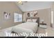 Virtually staged main bedroom featuring vaulted ceilings and neutral decor at 7720 Leavorite Dr, Las Vegas, NV 89128