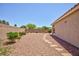 Low maintenance backyard with desert landscaping featuring rock ground cover and stepping stone pathway at 7816 Glowing Peak St, Las Vegas, NV 89131