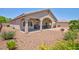 Open backyard with desert landscaping, covered patio, and ample space for outdoor activities at 7816 Glowing Peak St, Las Vegas, NV 89131
