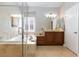 This bathroom features a glass enclosed shower, soaking tub, and granite countertops at 7816 Glowing Peak St, Las Vegas, NV 89131