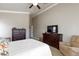 This bedroom features a ceiling fan, neutral walls, and an ensuite bathroom at 7816 Glowing Peak St, Las Vegas, NV 89131