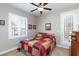 Cozy bedroom with a ceiling fan, window and patterned bedspread at 7816 Glowing Peak St, Las Vegas, NV 89131