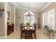 This dining room features a chandelier, wood table, and window with plantation shutters at 7816 Glowing Peak St, Las Vegas, NV 89131