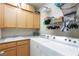 Functional laundry room with washer, dryer, sink, and storage cabinets at 7816 Glowing Peak St, Las Vegas, NV 89131