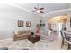 This living room features vaulted ceilings, tile floors, and a large sectional sofa at 7816 Glowing Peak St, Las Vegas, NV 89131
