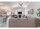 Cozy living room with vaulted ceilings, large sectional sofa, and sliding doors to the backyard at 7816 Glowing Peak St, Las Vegas, NV 89131