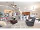 Bright and open living room flowing into the kitchen, featuring a ceiling fan and comfortable seating at 7816 Glowing Peak St, Las Vegas, NV 89131
