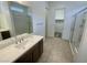 Modern bathroom featuring a large vanity, tiled floors, and a walk-in shower at 8550 Lost Pony St, Las Vegas, NV 89148