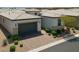 Charming single-story home featuring a well-manicured front yard and a two-car garage with stone accents at 8550 Lost Pony St, Las Vegas, NV 89148