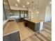 Modern kitchen with an island, stainless steel appliances, granite countertops, and tile backsplash at 8550 Lost Pony St, Las Vegas, NV 89148
