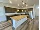 Contemporary kitchen with granite counters, a spacious island, stainless steel appliances, and stylish pendant lighting at 8550 Lost Pony St, Las Vegas, NV 89148
