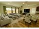 Modern living room showcasing a comfortable seating area, stylish furnishings, and a dining area with a glass-top table at 8550 Lost Pony St, Las Vegas, NV 89148